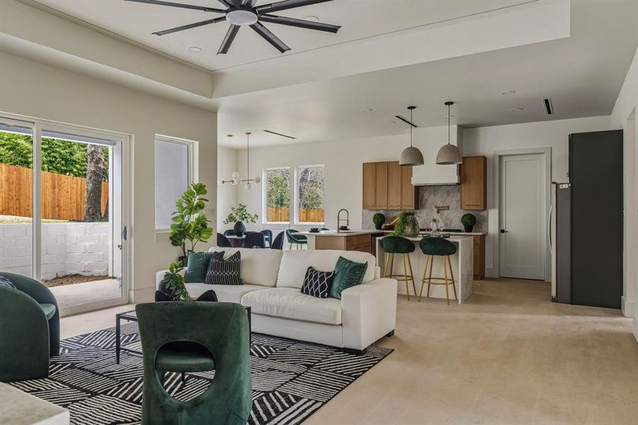 Living area featuring light wood-style floors, recessed lighting, and a ceiling fan