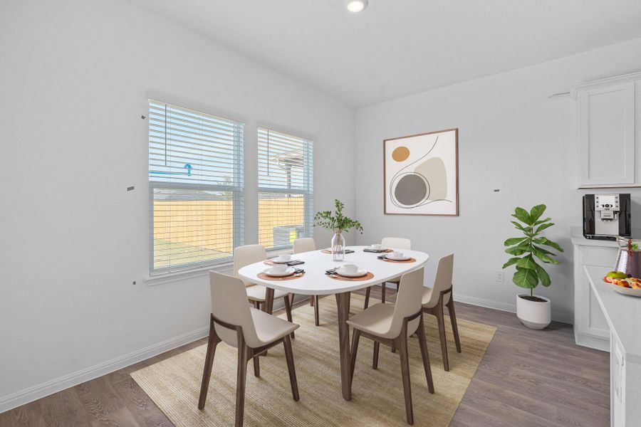 Dining room with light wood-style floors and recessed lighting Dining room with light wood-style floors and recessed lighting
