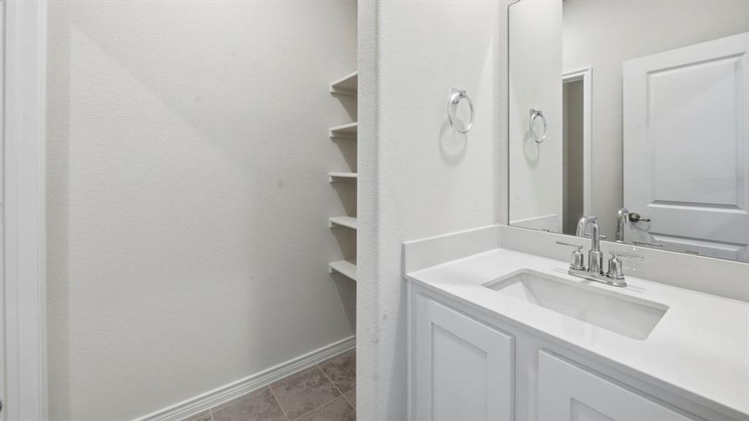 Bathroom with vanity and light tile patterned floors