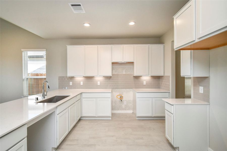 Welcome to a dream kitchen that exceeds expectations! This generously spacious layoutboasts high ceilings, soft-close cabinets, granite countertops, stainless steel appliances, a sleek tile backsplash, and recessed lighting. An extended counter area adds an extra layer of functionality. The open concept seamlessly connects this culinary haven to the expansive family room, creating the perfect hub for gatherings. Sample photo of completed home with similar floor plan. Actual colors and selections may vary. Welcome to a dream kitchen that exceeds expectations! This generously spacious layoutboasts high ceilings, soft-close cabinets, granite countertops, stainless steel appliances, a sleek tile backsplash, and recessed lighting. An extended counter area adds an extra layer of functionality. The open concept seamlessly connects this culinary haven to the expansive family room, creating the perfect hub for gatherings. Sample photo of completed home with similar floor plan. Actual colors and selections may vary.