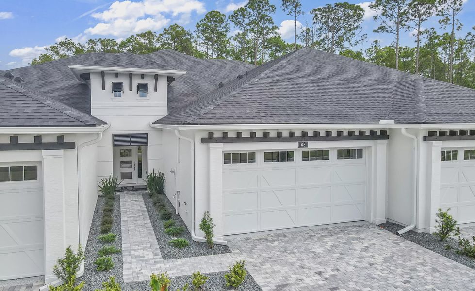 Front exterior of a new home in Plantation Bay, Ormond Beach, FL, highlighting curb appeal (Image 2).