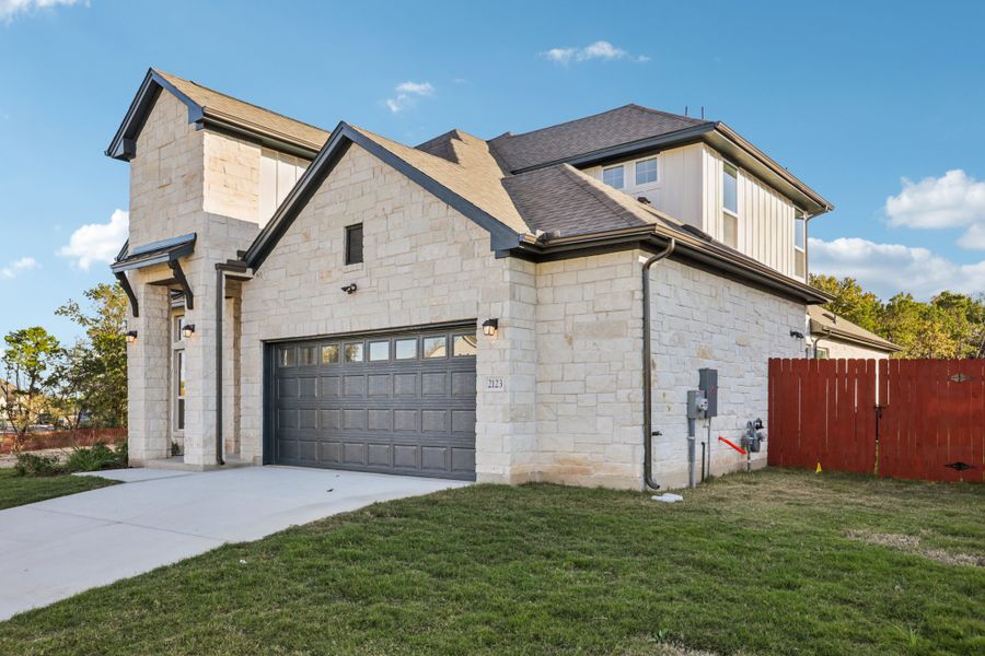 Front exterior of a new home in Sauls Ranch, Round Rock, TX, highlighting curb appeal (Image 2).