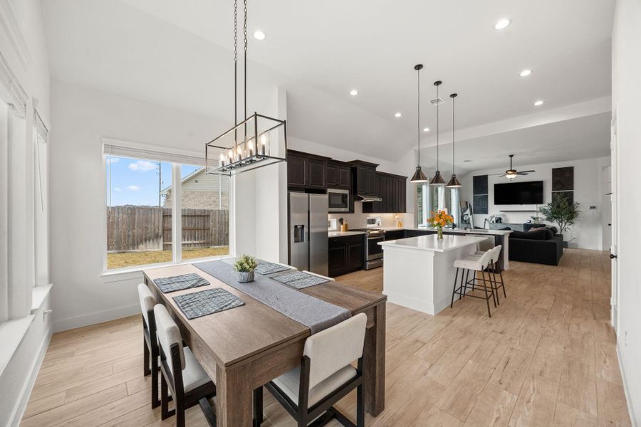 Wood-look tile flooring extends throughout the main living areas, adding durability and a cohesive finish alongside quartz surfaces and designer lighting.
