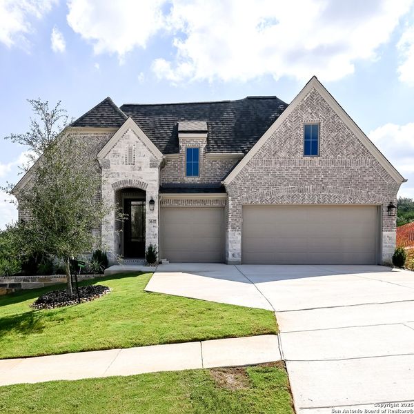 Front exterior of a new home in Johnson Ranch 55', Bulverde, TX, highlighting curb appeal (Image 19). Front exterior of a new home in Johnson Ranch 55', Bulverde, TX, highlighting curb appeal (Image 19).
