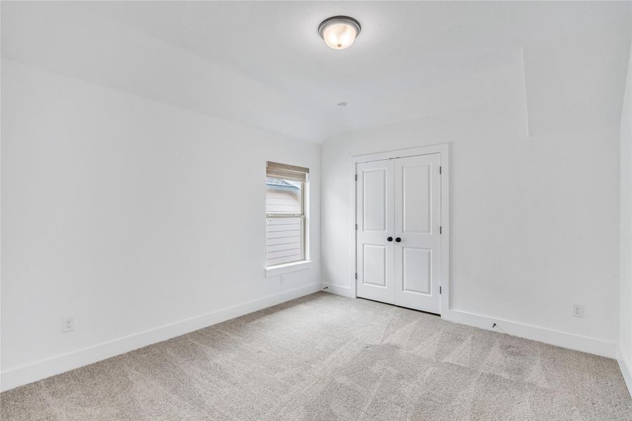 A well-lit bedroom offering a cozy ambiance and a window for natural illumination.