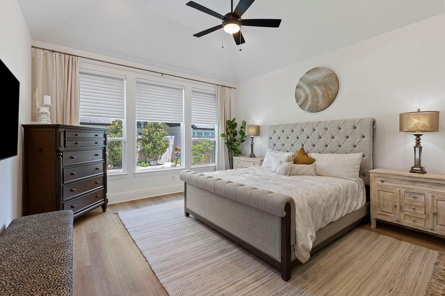 The light-filled primary bedroom offers a peaceful atmosphere perfect for rest and relaxation.