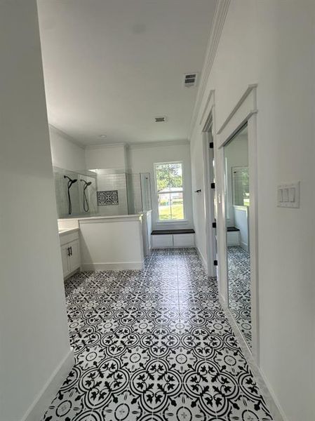 Full bath featuring ornamental molding, a tile shower, and vanity Full bath featuring ornamental molding, a tile shower, and vanity