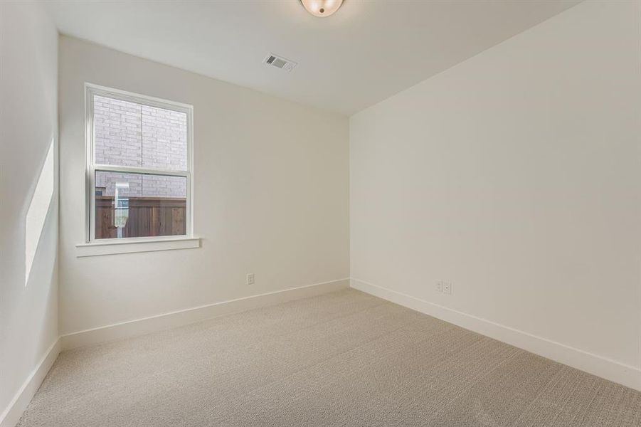 Carpeted spare room featuring baseboards Carpeted spare room featuring baseboards