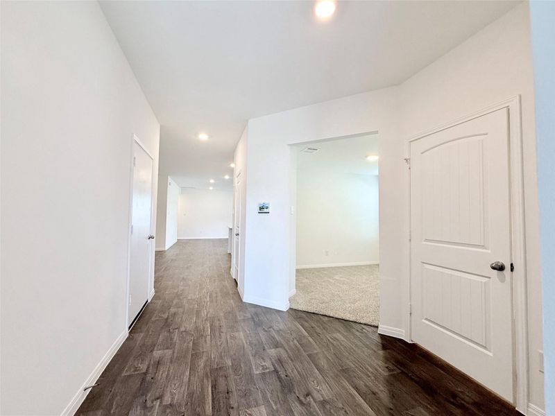 Hall featuring recessed lighting and dark wood-style flooring Hall featuring recessed lighting and dark wood-style flooring