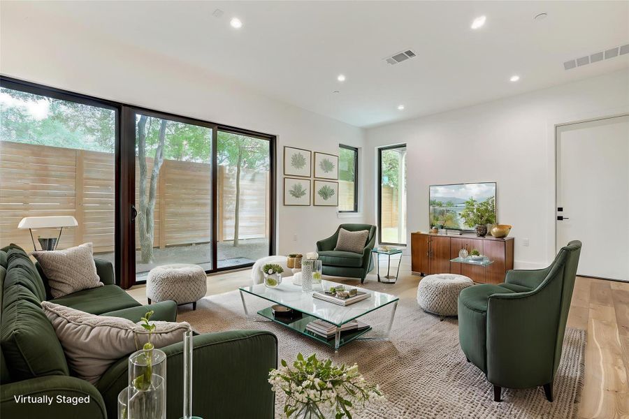 Living room featuring wood finished floors and recessed lighting Living room featuring wood finished floors and recessed lighting