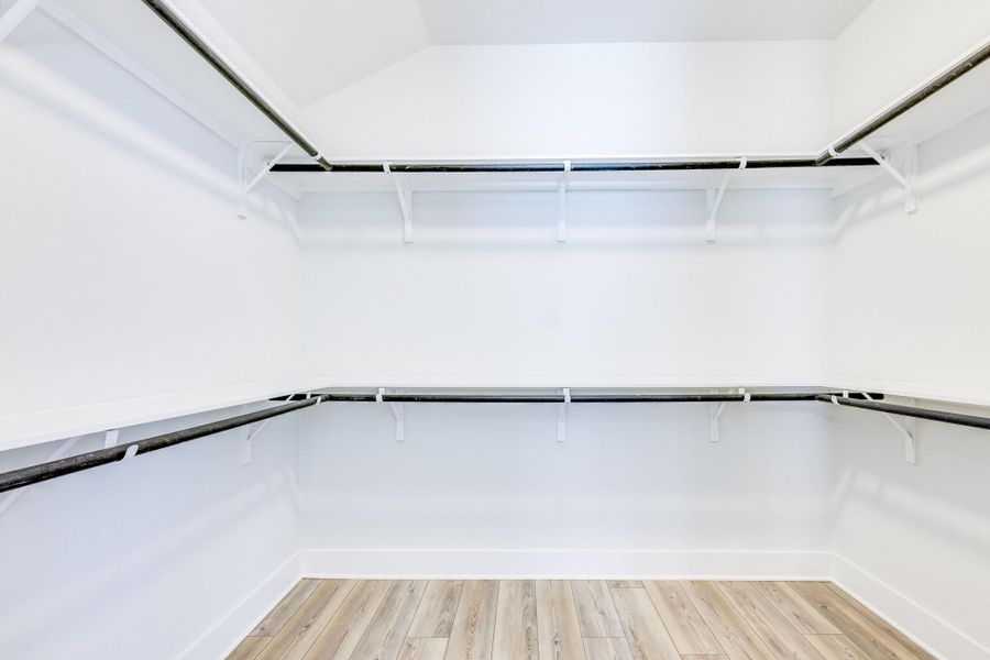 Spacious closet featuring light wood-style flooring