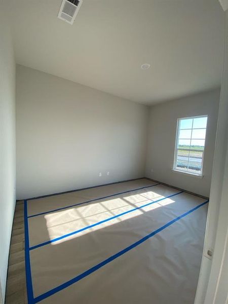 Room featuring light gray painted walls and wood-finish flooring