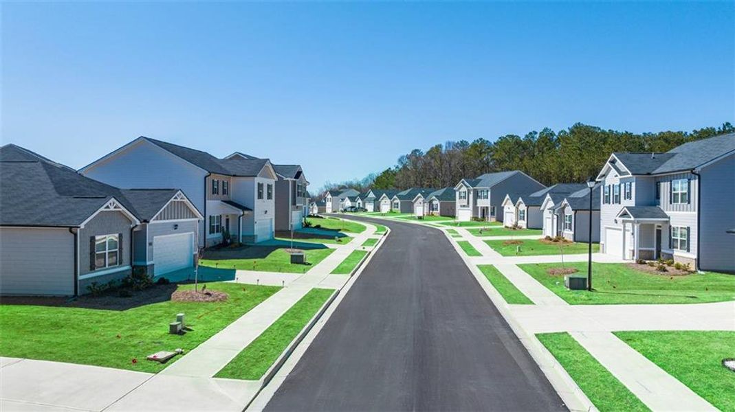 Front exterior of a new home in Champion's Run, Lithonia, GA, highlighting curb appeal (Image 18).