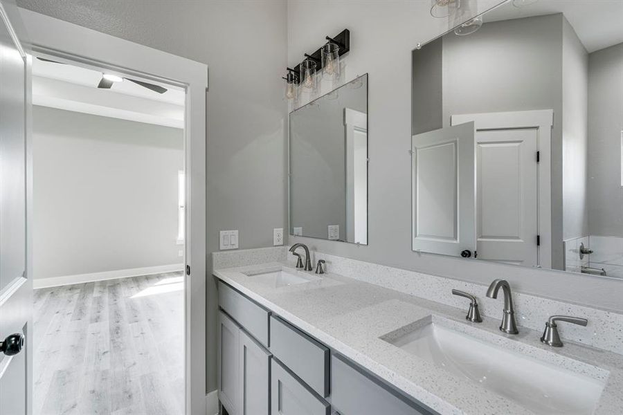 Bathroom featuring hardwood / wood-style floors and dual bowl vanity