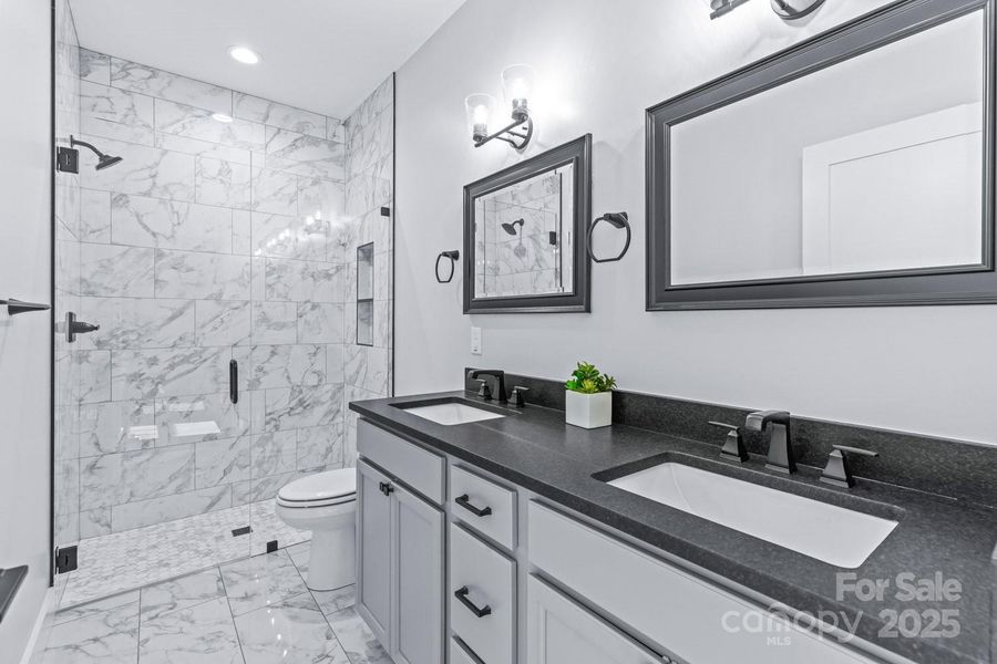 After harvesting your vegetables, unwind in the  spacious spa-like primary suite bathroom.