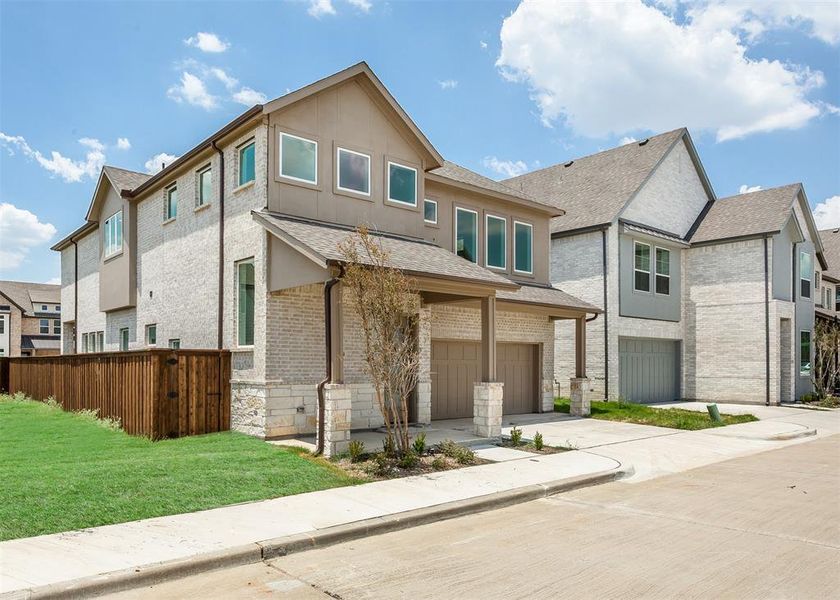 View of front of home featuring a garage and a front lawn