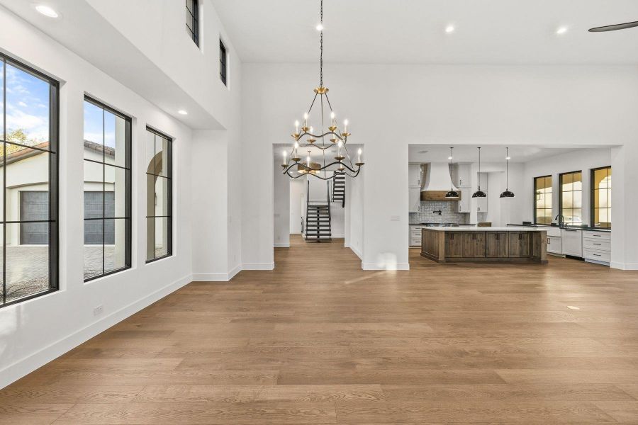 Unfurnished dining area with dark wood-style floors and a chandelier