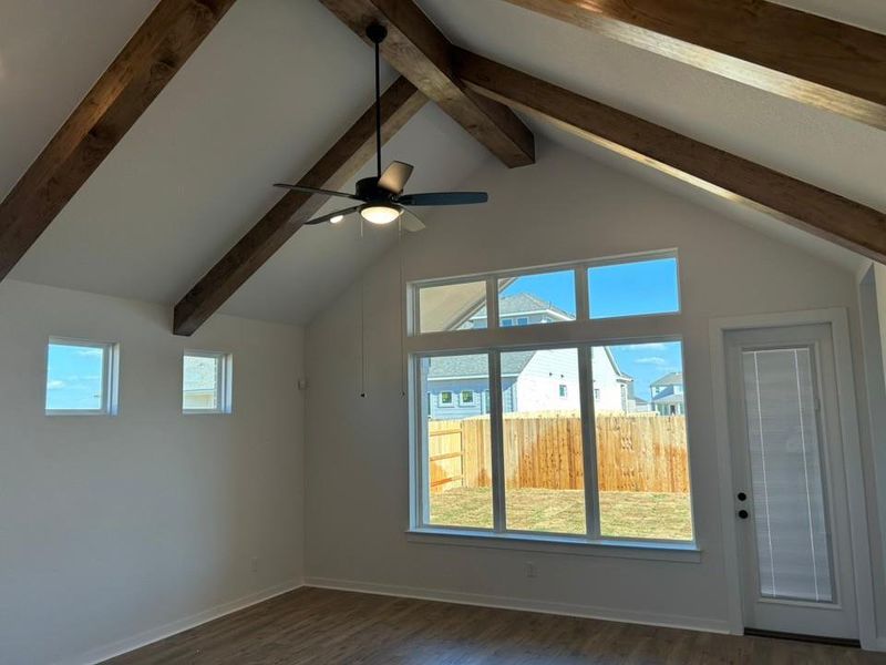 Additional living space featuring dark wood finished floors and baseboards