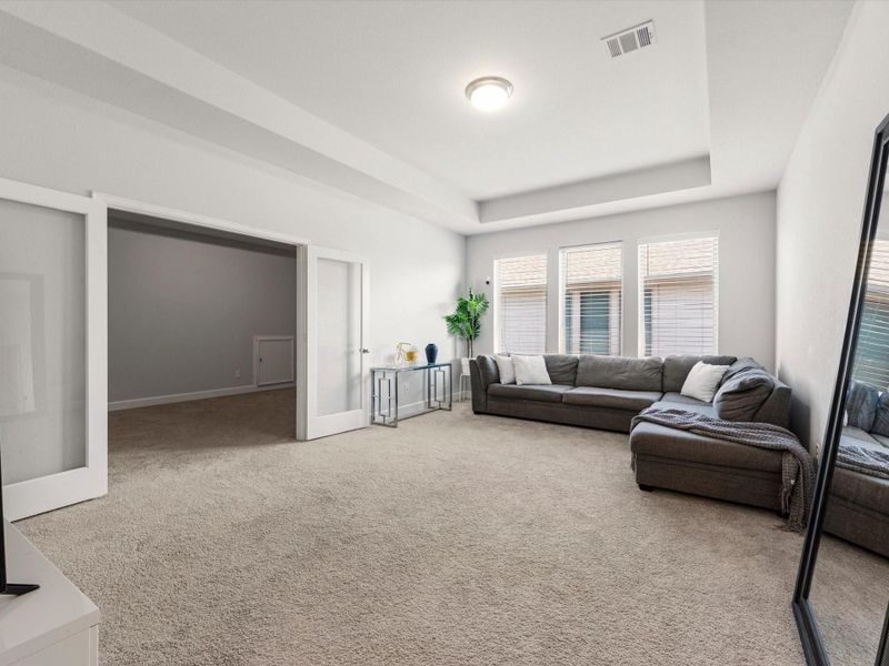 Large, light and bright game room adjacent to the media room with double doors.