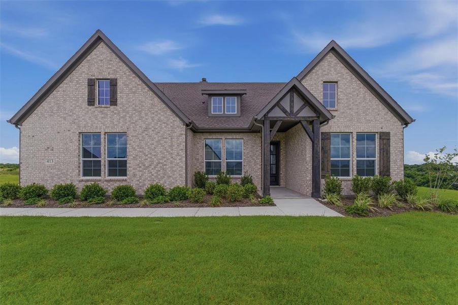 Brick exterior with a dark-pitched roof and dormer window Brick exterior with a dark-pitched roof and dormer window