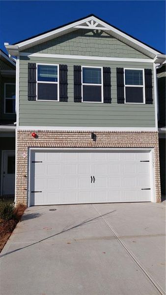 Front exterior of a new home in The Enclave Townhomes, Hampton, GA, highlighting curb appeal (Image 22).