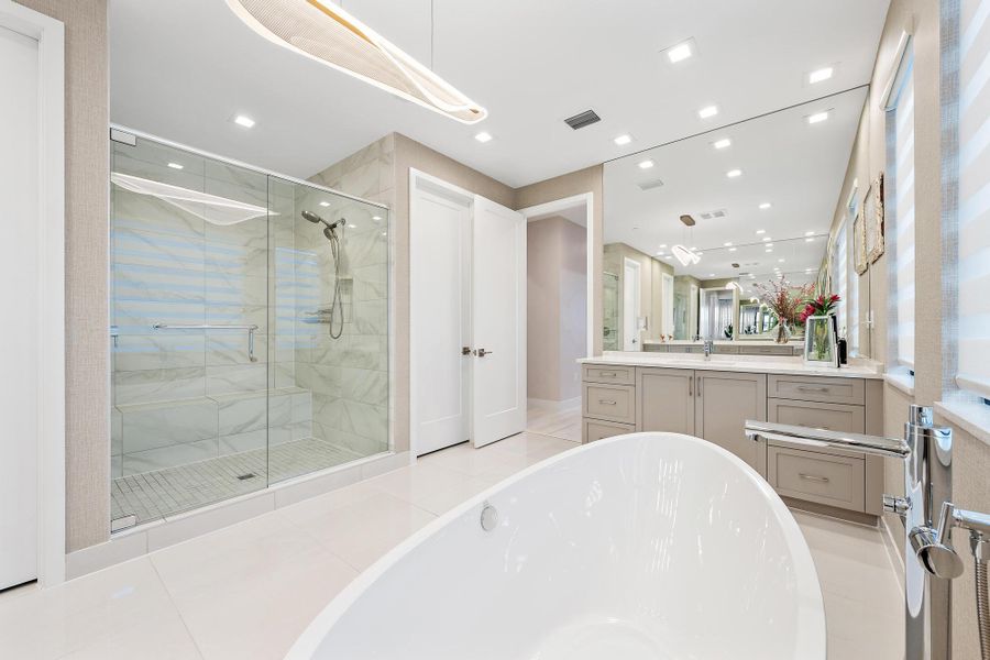Large walk-in shower, freestanding tub, upgraded cabinetry, premium countertops, and soft-close vanity drawers.