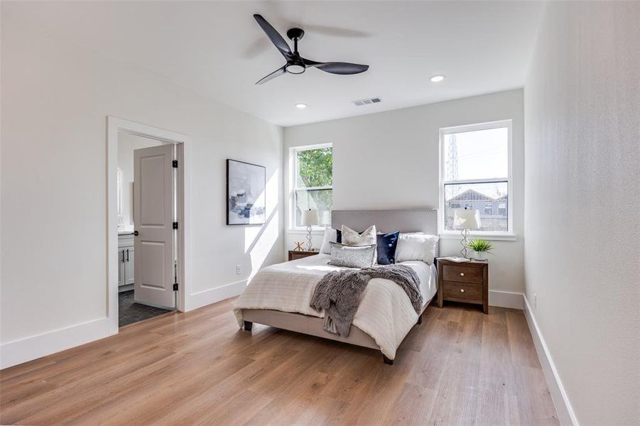 Bedroom featuring light wood-style flooring, recessed lighting, connected bathroom, and ceiling fan Bedroom featuring light wood-style flooring, recessed lighting, connected bathroom, and ceiling fan