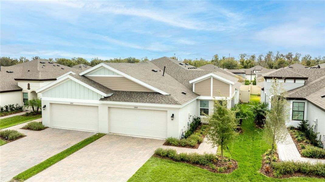 Front exterior of a new home in Crosswind Point, Parrish, FL, highlighting curb appeal (Image 21).