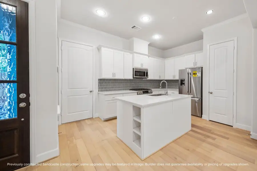 The heart of the home. Anchored by an island with a sink and ample pantry storage, this kitchen is where memories are made.