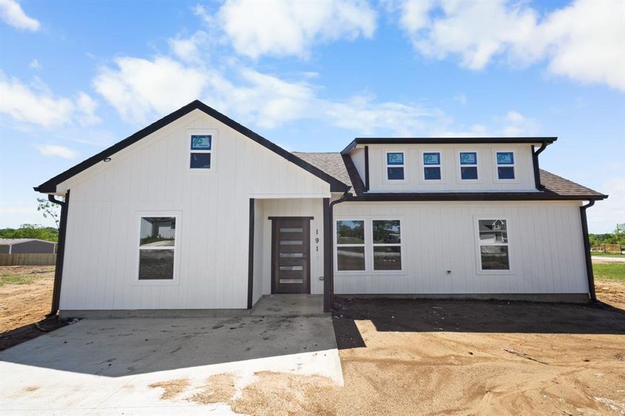 Modern farmhouse with a shingled roof Modern farmhouse with a shingled roof