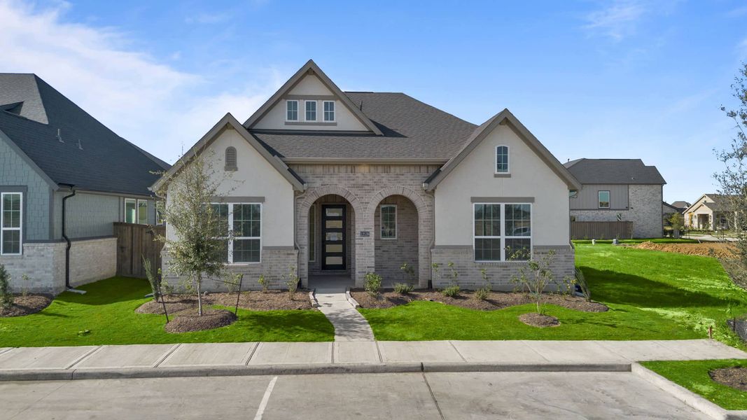Front exterior of a new home in Riceland, Mont Belvieu, TX, highlighting curb appeal (Image 19). Front exterior of a new home in Riceland, Mont Belvieu, TX, highlighting curb appeal (Image 19).
