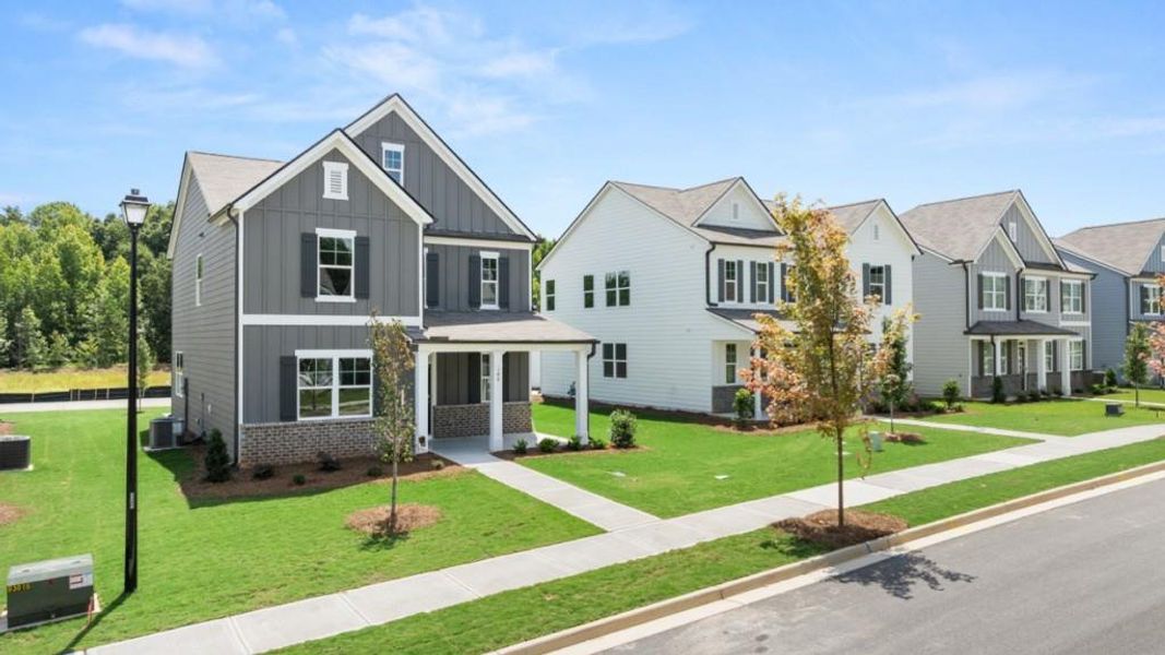 Front exterior of a new home in Braselton Village, Braselton, GA, highlighting curb appeal (Image 2). Front exterior of a new home in Braselton Village, Braselton, GA, highlighting curb appeal (Image 2).