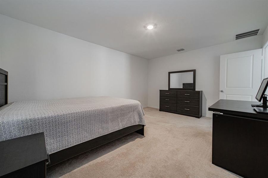Bedroom featuring light colored carpet