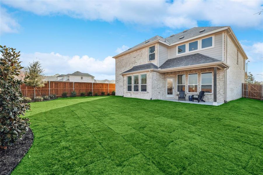 Back of house featuring a patio area and a lawn