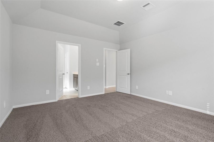 The private primary suite efficiently connects the sleeping area with the dedicated bathroom and generous closet.