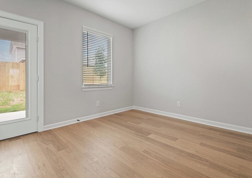 Dining room with a window and full lite door that leads to the backyard