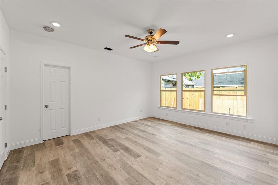 Empty room featuring ceiling fan and light hardwood / wood-style floors