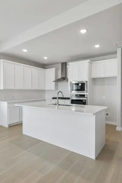 Kitchen in the Stanley II home plan by Trophy Signature Homes – REPRESENTATIVE PHOTO