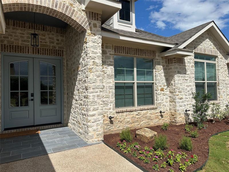 Stone facade with brick accents and arched entryway