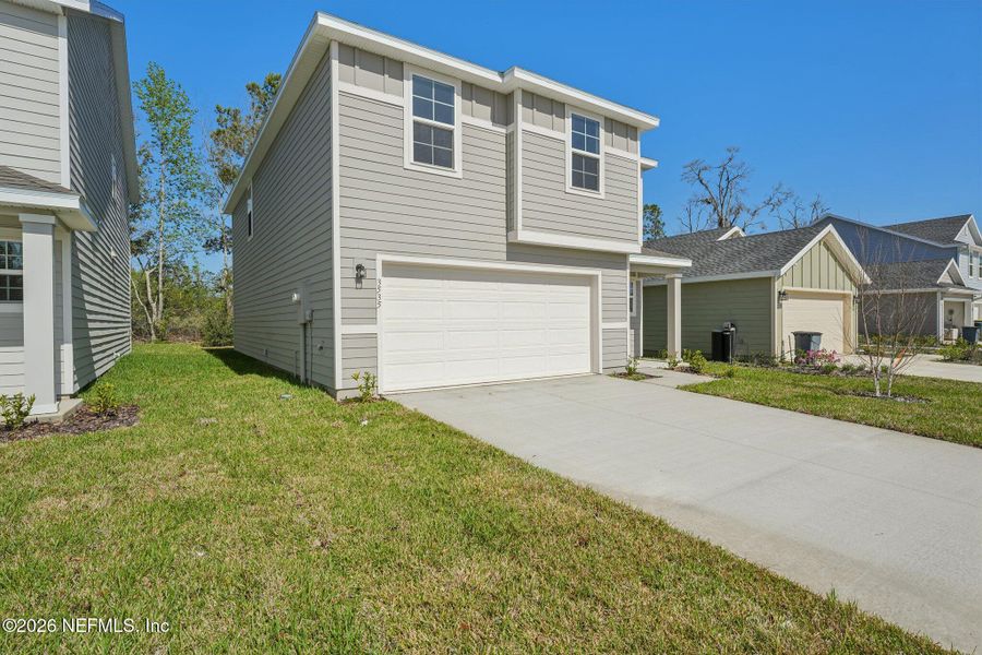 Front exterior of a new home in Kings Landing, Jacksonville, FL, highlighting curb appeal (Image 27).