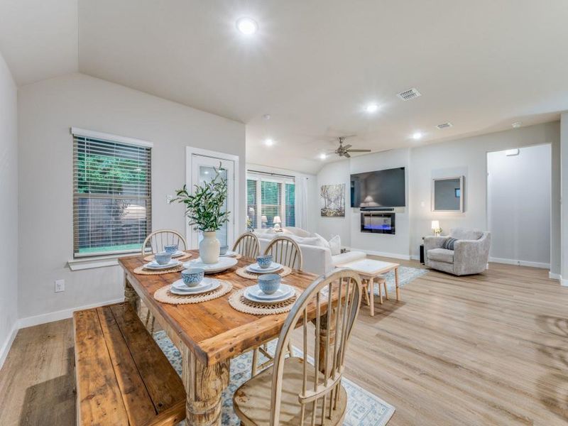 Dining area with light wood-type flooring, lofted ceiling, and ceiling fan