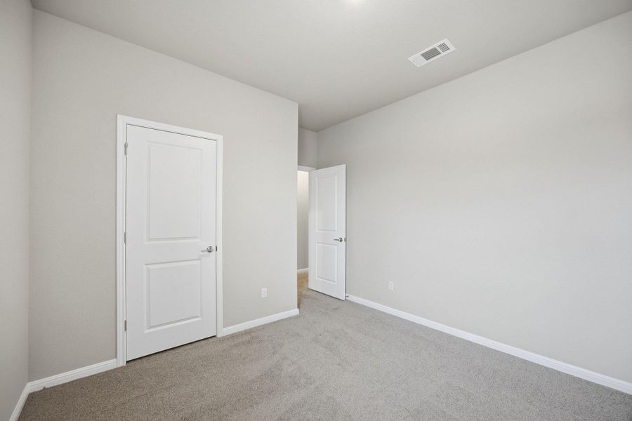 Unfurnished bedroom featuring baseboards and carpet floors