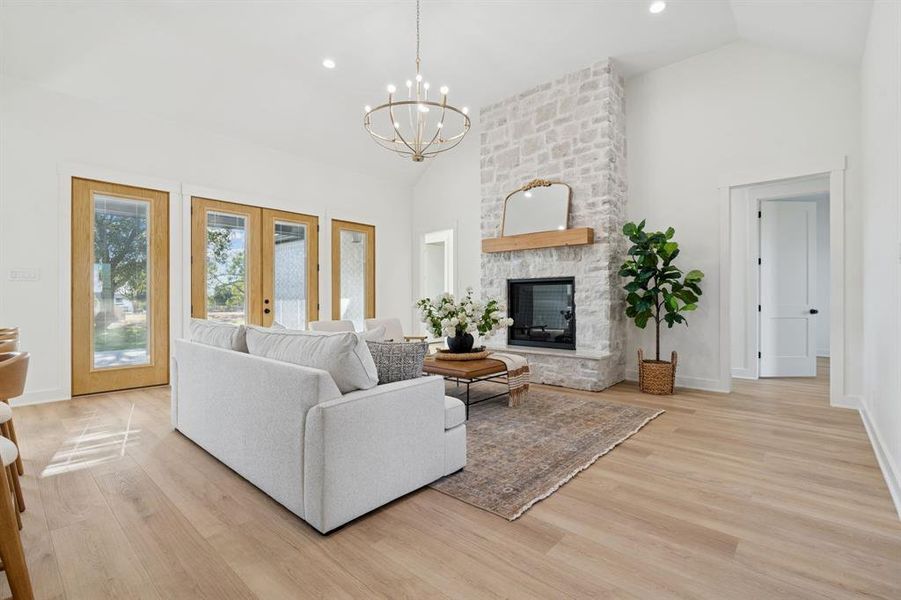 Wide-plank white oak-look luxury vinyl plank flooring. ZERO carpet in this home. Stone fireplace to ceiling.