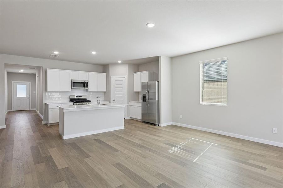 Kitchen and Dining Room in the Holden home plan by Trophy Signature Homes – REPRESENTATIVE PHOTO Kitchen and Dining Room in the Holden home plan by Trophy Signature Homes – REPRESENTATIVE PHOTO