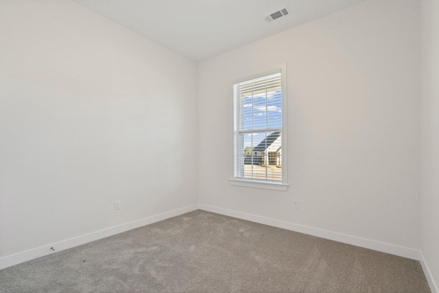 Carpeted empty room with baseboards