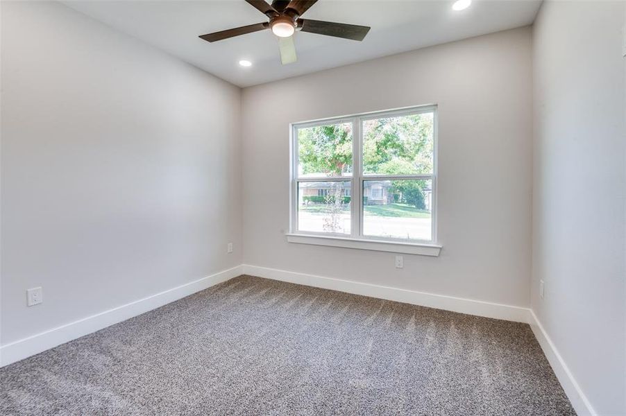 Spare room featuring ceiling fan and carpet flooring