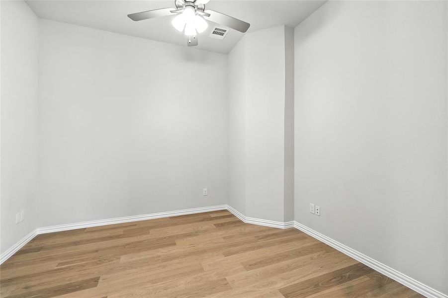 Unfurnished room with light wood-style floors and ceiling fan Unfurnished room with light wood-style floors and ceiling fan