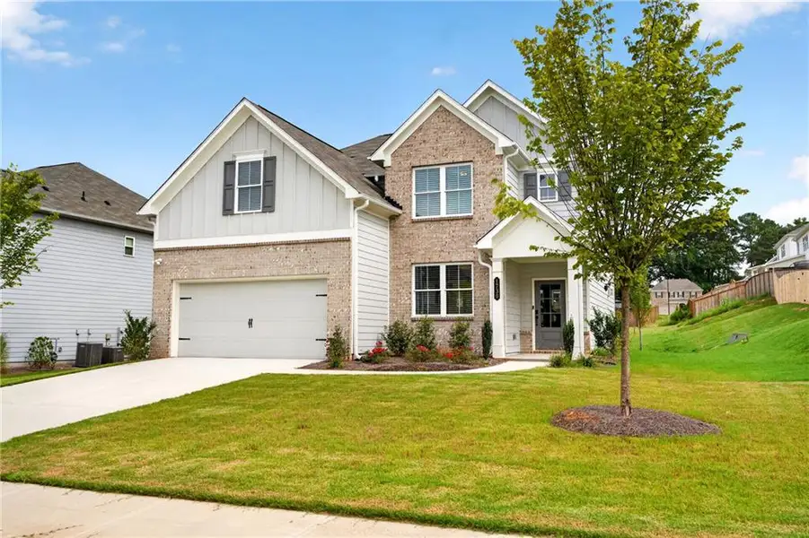 Front exterior of a new home in Avenbrook, Mableton, GA, highlighting curb appeal (Image 28).
