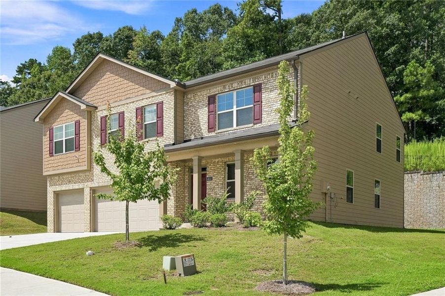 Front exterior of a new home in The Enclave at Flat Rock Hills, Stonecrest, GA, highlighting curb appeal (Image 1). Front exterior of a new home in The Enclave at Flat Rock Hills, Stonecrest, GA, highlighting curb appeal (Image 1).