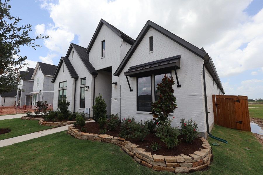 Front exterior of a new home in Dunham Pointe, Cypress, TX, highlighting curb appeal (Image 15). Front exterior of a new home in Dunham Pointe, Cypress, TX, highlighting curb appeal (Image 15).